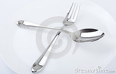 Dinner plate, spoon and fork. Stock Photo