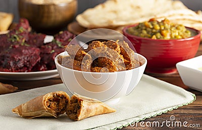 Dinner Set with Chicken Tikka Massala on a Wooden Table Stock Photo