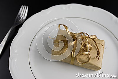 Dinner Setting with Gift. Suprize eating or gift dinner concept Stock Photo