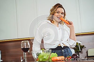 Attractive curly haired girl eating healthy food Stock Photo