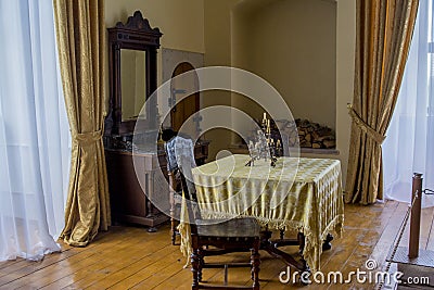 Dinning room interior with table, chairs, statue in the ancient old castle Editorial Stock Photo