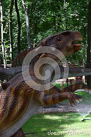 Dinosaur statue in the forest park in nature for background. Wuerlosaurus - Early Jurassic 155-150 million years ago Editorial Stock Photo