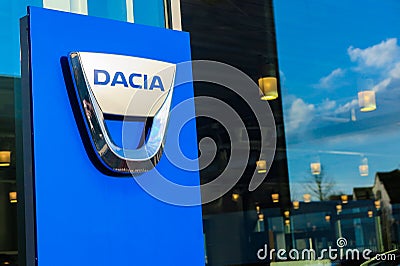 Isolated lettering of rumanian automobile manufacturer Dacia against window of car dealer Editorial Stock Photo