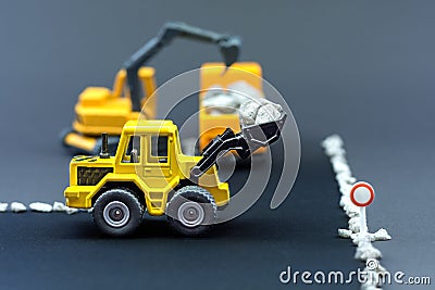 Diorama road construction with yellow construction machinery models Stock Photo