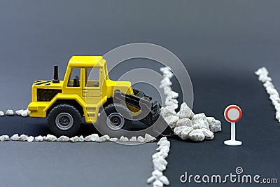 Diorama road construction with yellow construction machinery models Stock Photo