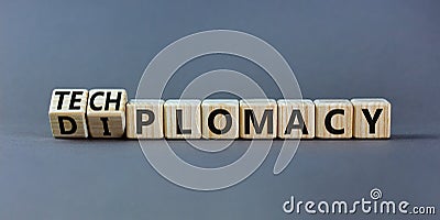 Diplomacy or techplomacy symbol. Turned wooden cubes and changed the concept word diplomacy to techplomacy. Beautiful grey Stock Photo