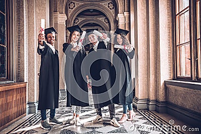 Diplomas in diversity!Shot of a diverse group of university students holding their diplomas Stock Photo