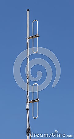 Dipole antenna for telecommunications with blue sky background. Stock Photo