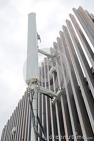 Dipole antenna for telecommunications contrasting white sky back Stock Photo