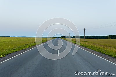 Direct asphalt road in the middle of a wheat field with markings Stock Photo