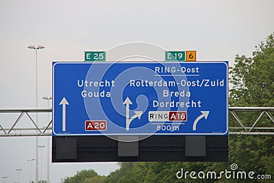 Direction sign in blue and white heading Gouda and Utrecht on motorway A20 / E25 and Breda on the E19 Stock Photo