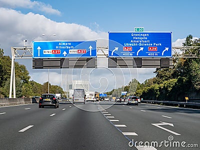 Direction sign information on overhead gantry, orbital motorway A27 at exit to A28, Utrecht, Netherlands Editorial Stock Photo