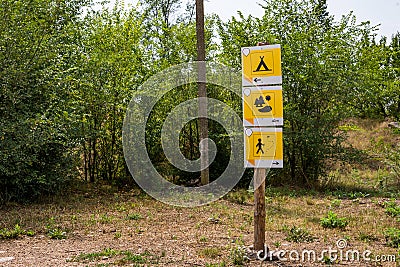 Direction sign on the trail in the forest, where there is a camping, lake, walking path for the tourist Stock Photo