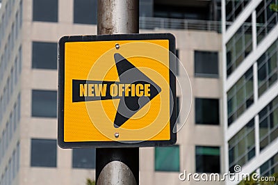 Directional sign with conceptual message NEW OFFICE Stock Photo