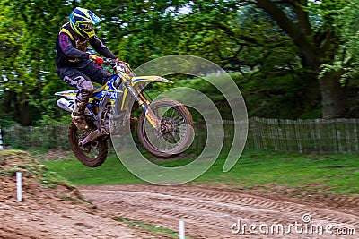 Dirt bike rider mid air after taking off from a jump Editorial Stock Photo