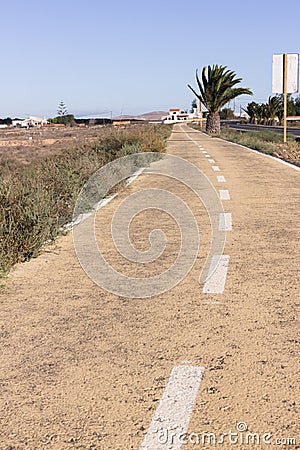 Dirt road in Spain, Canarian islands. Dividing centre line. Bicycle track Stock Photo