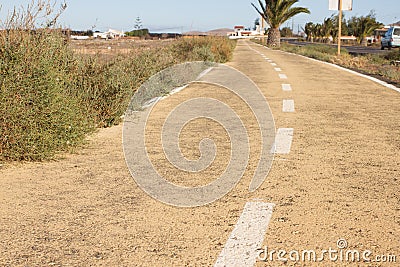 Dirt road in Spain, Canarian islands. Dividing centre line. Bicycle track Stock Photo