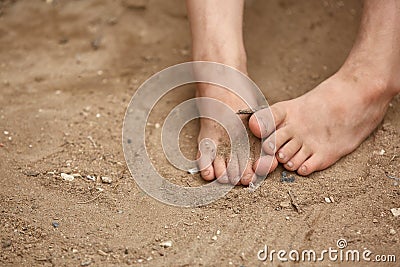 Dirty bare feet of poor little girl, selective focus, shallow depth of field. Stock Photo