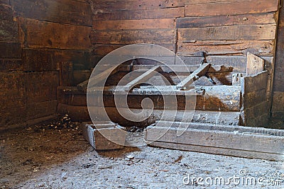 Dirty barn with a manger for animals Stock Photo