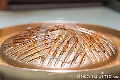 Dirty Brass Pan use electricity for BBQ grill Stock Photo