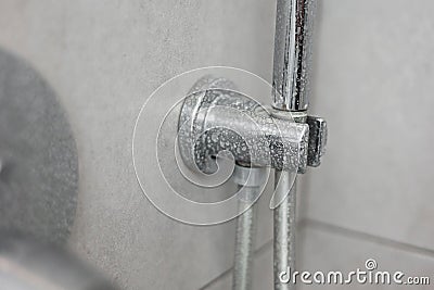 Dirty calcified shower mixer tap, faucet with limescale on it, plaque from hard water, Chrome plated shower, close up Stock Photo