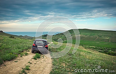 Dirty car crossover. Fields with vineyards. Beautiful nature with hills. Stock Photo