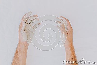 Dirty of clay and mud man hands isolated on white. Creative and abstract photo of human hands. Delicate humanity. Selective focus Stock Photo