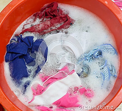 Dirty clothes soak in tub Stock Photo