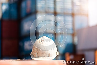 Dirty construction safety white helmet at container yard background Stock Photo