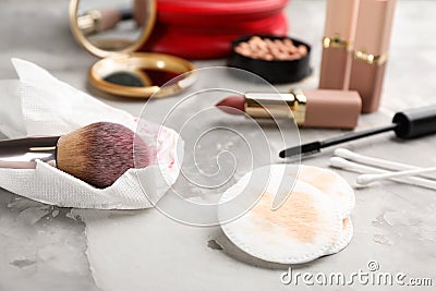 Dirty cotton pads, swabs, tissue and cosmetic products on grey table Stock Photo