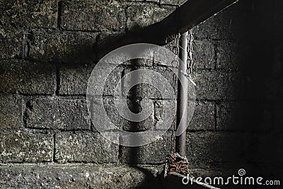 Dirty, Dark, Spooky, Scary and Mystic Farm Room for the Cows with Visible Hanging Rusty Chain on Partition Stock Photo