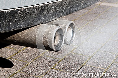 Dirty dual exhaust pipes of a car, emissions test Stock Photo