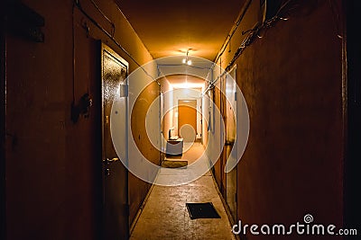 Dirty empty dark corridor in apartment building, doors, lighting lamps Stock Photo