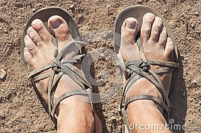 Dirty feet in sandals Stock Photo