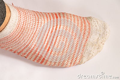Dirty female striped socks on a white background top view Stock Photo