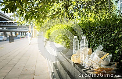 Dirty food waste,rubbish along the walkway,tourists littering or leaving in public areas,concept of throw your trash in a trash Stock Photo