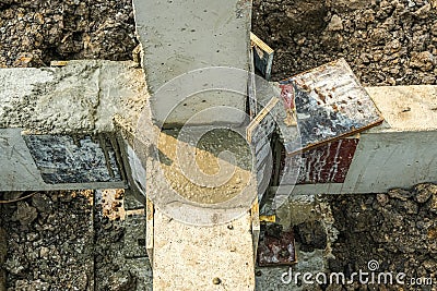 Dirty foundation pillar in pit before making joint concrete for reinforce structure. connect brickwork cement construction link ju Stock Photo