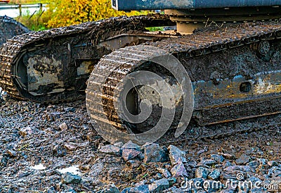 Dirty iron tracks on an excavator Stock Photo