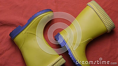 Dirty kids yellow rubber boots top view Stock Photo