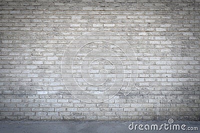 Dirty old grungy looking cement brick wall with a pathway running in front of it Stock Photo