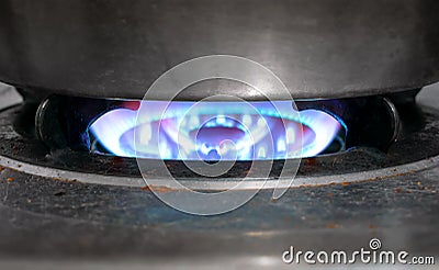 Dirty Old Natural Gas Stove Cooking with Full Flame On. Stock Photo