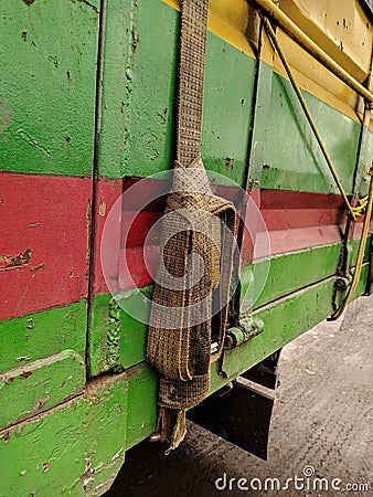 dirty old rope details and a dirty old canvas covered truck on a truck for transport. truck belt, safety Stock Photo