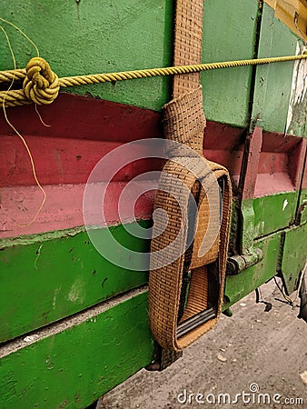 dirty old rope details and a dirty old canvas covered truck on a truck for transport. truck belt, safety Stock Photo