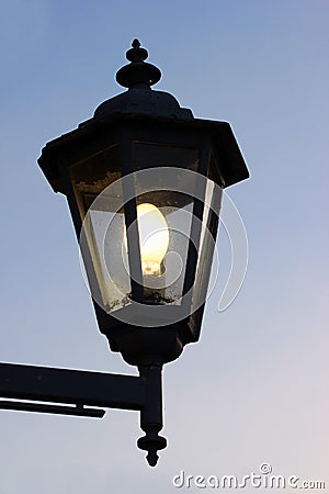 Dirty old street lamp against twilight background Stock Photo