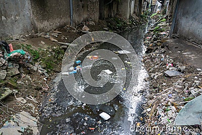 Dirty polluted waste water in big city with garbages. Environment pollution. Urban environment issues in developing countries Stock Photo