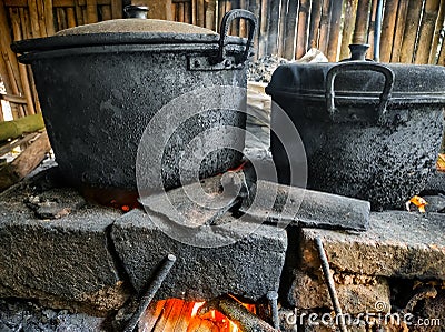 Dirty pots blackened by wood-burning smoke. Indonesian traditional cookware Stock Photo