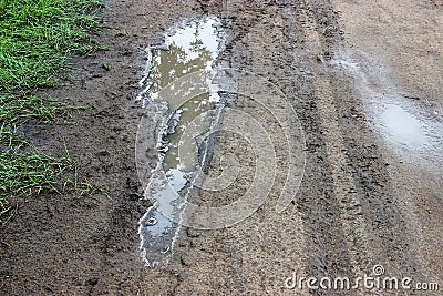 Dirty puddle on the country road Stock Photo