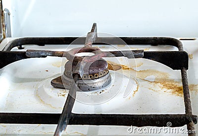 Dirty rusty switch off gas stove burner. Stock Photo