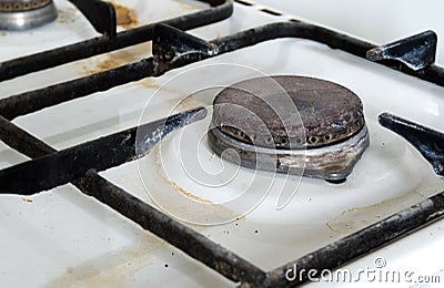 Dirty rusty switch off gas stove burner. Stock Photo