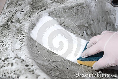 A dirty sponge remains on the dirty sink. House cleaning Stock Photo